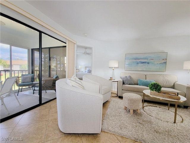 living room featuring light tile patterned floors and ceiling fan