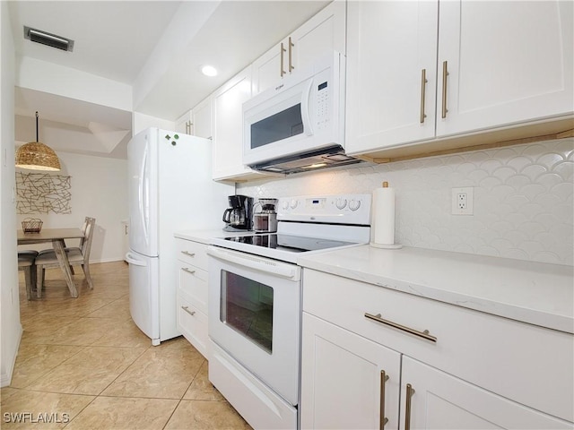 kitchen featuring hanging light fixtures, tasteful backsplash, white cabinets, white appliances, and light tile patterned floors