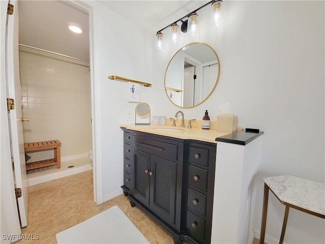 bathroom featuring tile patterned floors, vanity, toilet, and tiled shower