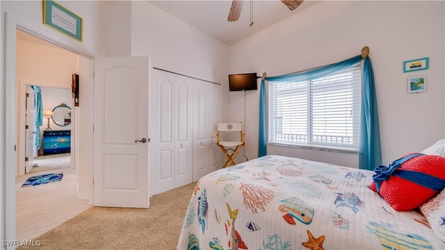 bedroom featuring ceiling fan, a closet, and light carpet