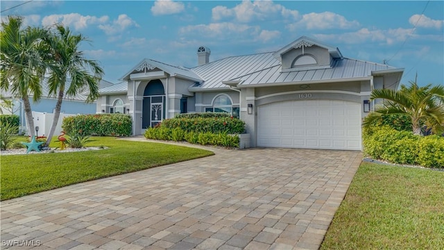 view of front of home featuring a garage and a front lawn