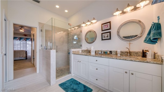 bathroom with vanity, ceiling fan, and walk in shower