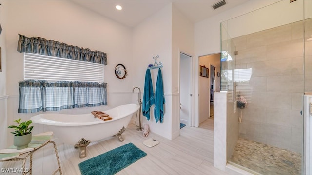 bathroom with separate shower and tub and a wealth of natural light