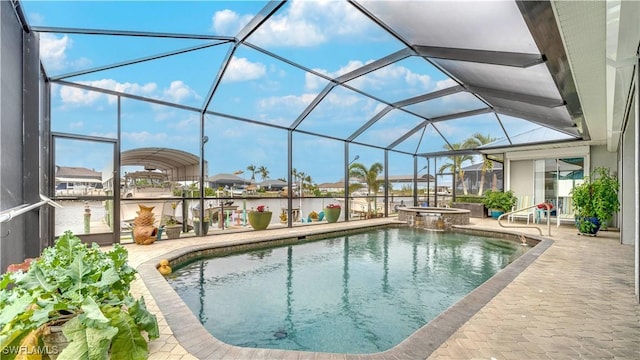 view of swimming pool featuring a patio area, a lanai, and an in ground hot tub