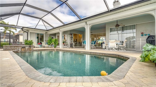 view of pool featuring a lanai, ceiling fan, a patio area, and an in ground hot tub