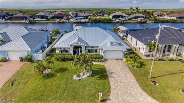 birds eye view of property with a water view