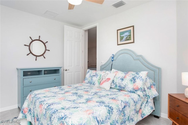 bedroom featuring light tile patterned floors, ceiling fan, visible vents, and baseboards