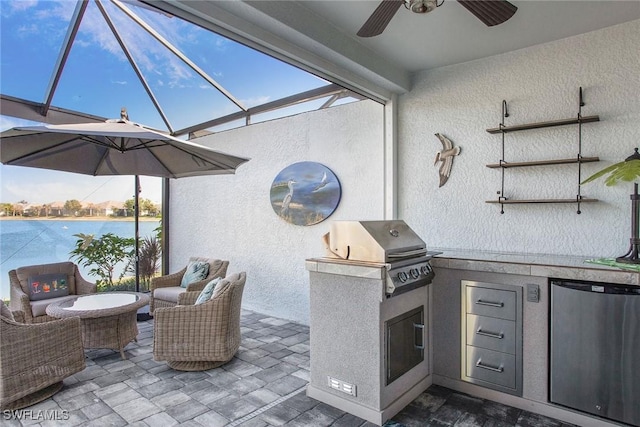 view of patio featuring glass enclosure, area for grilling, a grill, an outdoor living space, and a ceiling fan