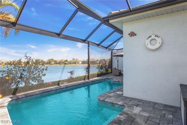 pool featuring a lanai, a water view, and a patio