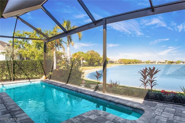 outdoor pool featuring a lanai, a water view, and a patio