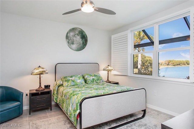 tiled bedroom with a ceiling fan and baseboards