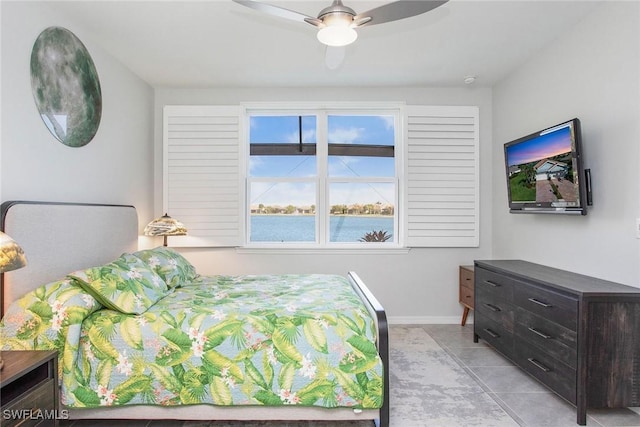 bedroom with baseboards, a ceiling fan, and light tile patterned flooring