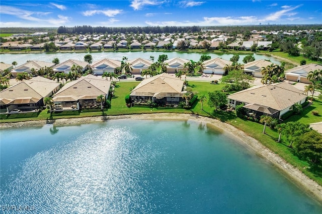 birds eye view of property with a water view and a residential view