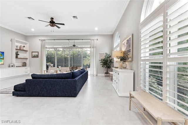 living room with ceiling fan and crown molding