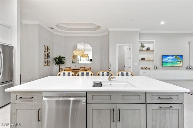 kitchen featuring appliances with stainless steel finishes, ornamental molding, sink, pendant lighting, and gray cabinets