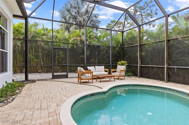 view of swimming pool featuring glass enclosure, a patio, and an outdoor hangout area