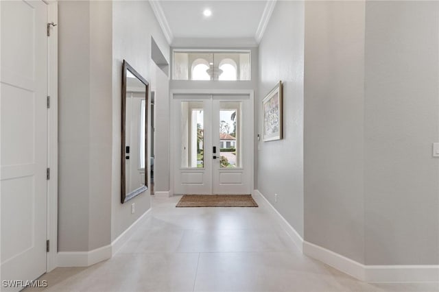 foyer with french doors and crown molding