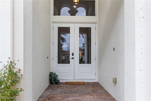 view of exterior entry featuring french doors