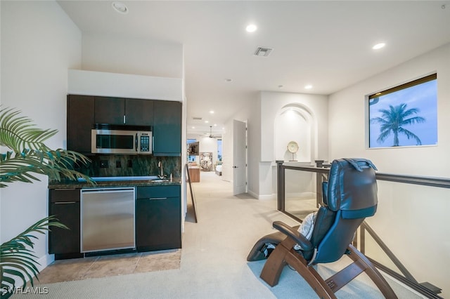 kitchen with backsplash, sink, and stainless steel appliances