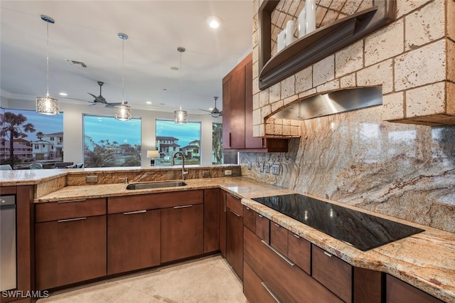 kitchen with backsplash, sink, pendant lighting, and black electric stovetop