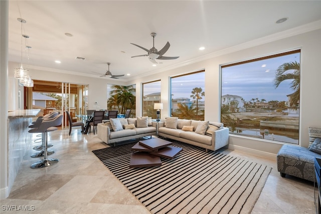 living room featuring ceiling fan, a wealth of natural light, and ornamental molding