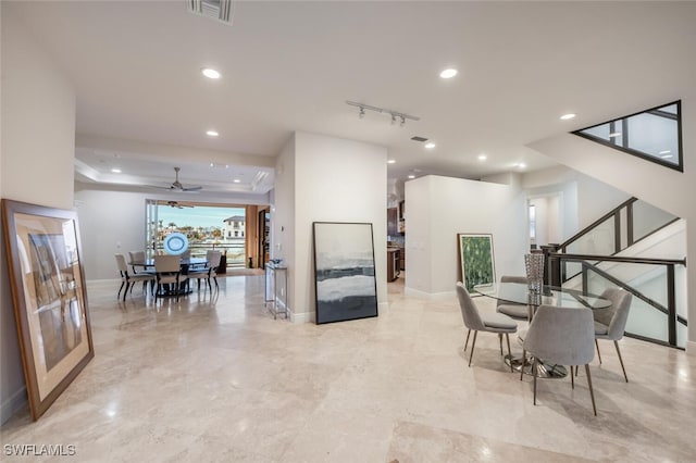 interior space with ceiling fan