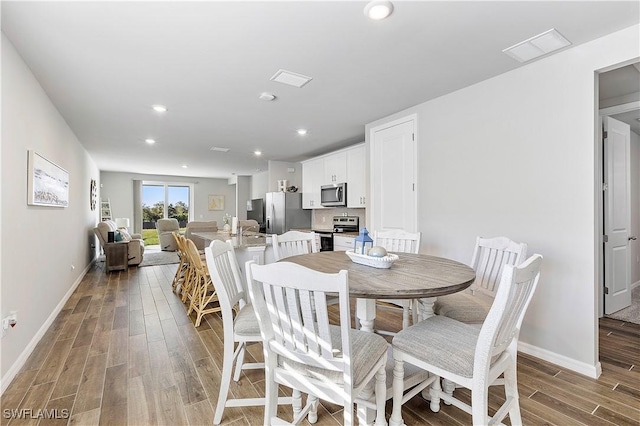 dining room with hardwood / wood-style flooring