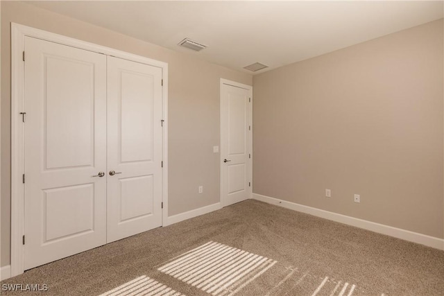 unfurnished bedroom featuring a closet and carpet flooring