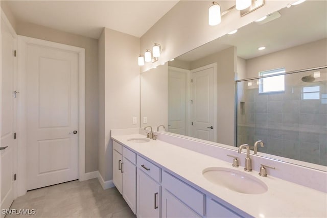 bathroom featuring a shower with door, tile patterned flooring, and vanity