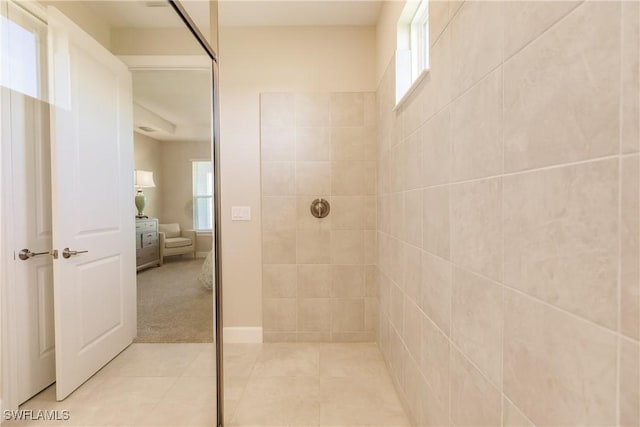 bathroom featuring tiled shower and tile patterned floors