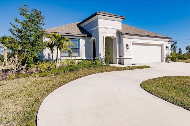 view of front of house with a front yard and a garage