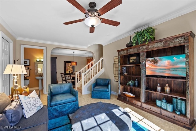 tiled living room featuring ceiling fan and ornamental molding