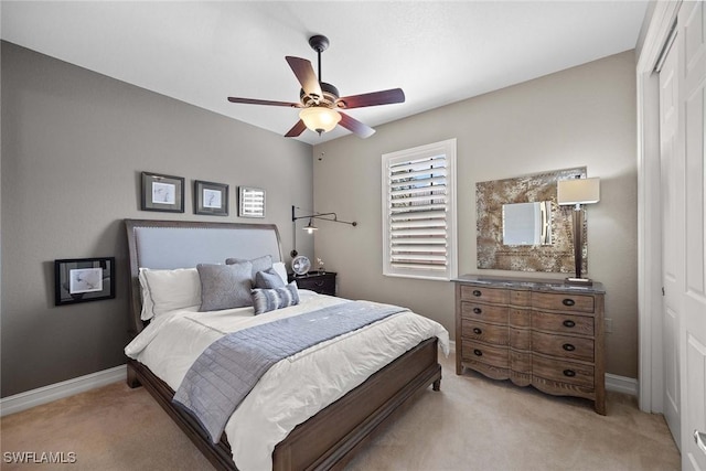 carpeted bedroom with ceiling fan and a closet