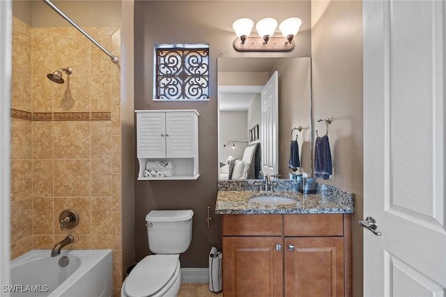 full bathroom featuring toilet, vanity, and tiled shower / bath