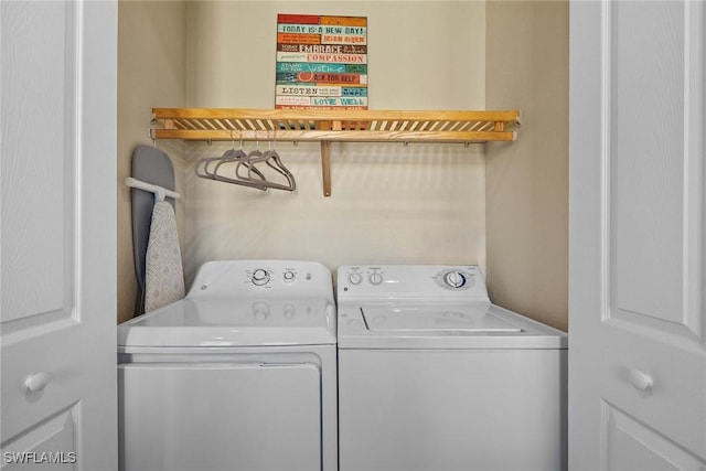 clothes washing area with washer and clothes dryer