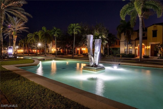 view of pool at night