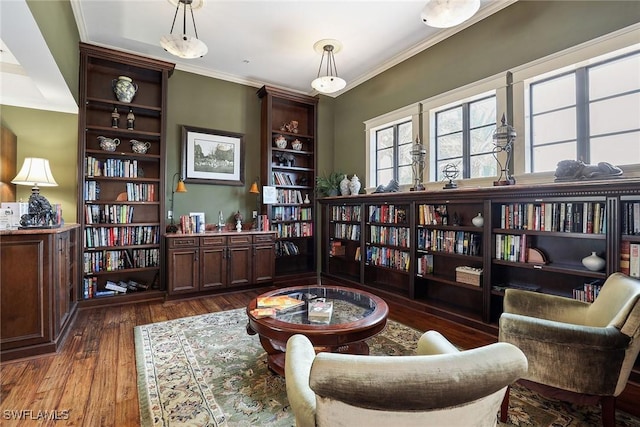 living area featuring dark wood-type flooring and crown molding