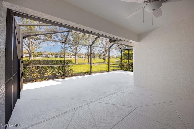 sunroom / solarium featuring ceiling fan