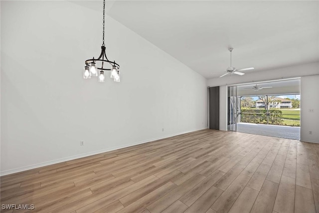 interior space with light hardwood / wood-style flooring, lofted ceiling, and an inviting chandelier