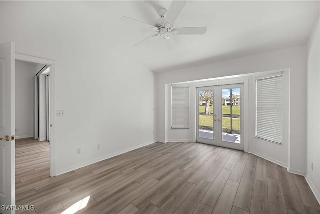 spare room with ceiling fan, french doors, and light hardwood / wood-style flooring