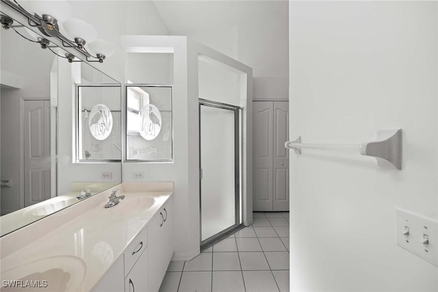 bathroom with tile patterned floors, vanity, and walk in shower