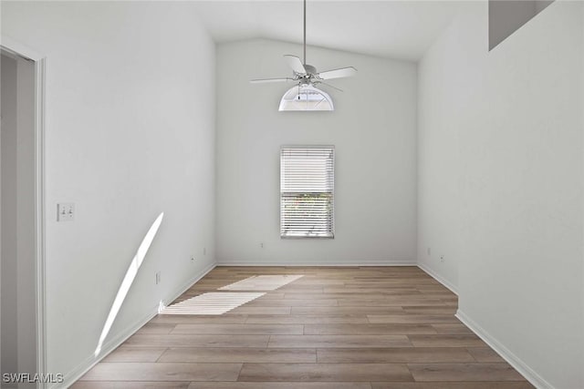 unfurnished room featuring lofted ceiling, light wood-type flooring, and ceiling fan