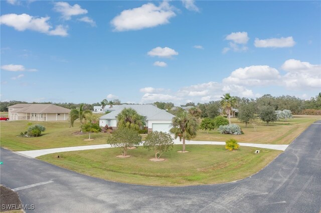 view of front of property with a front yard and a garage