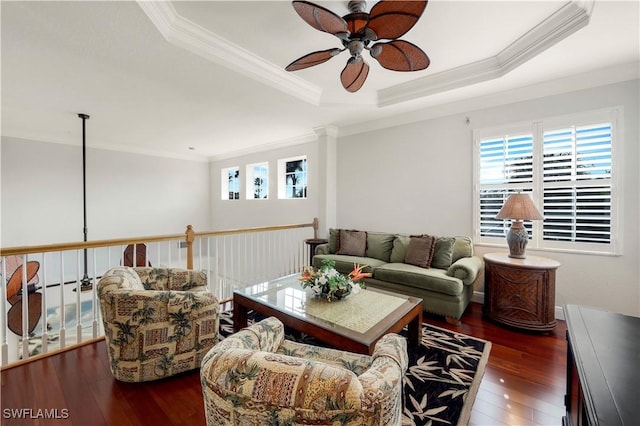 living room featuring a tray ceiling, dark hardwood / wood-style floors, crown molding, and ceiling fan