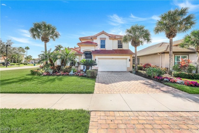 view of front of house featuring a front yard and a garage