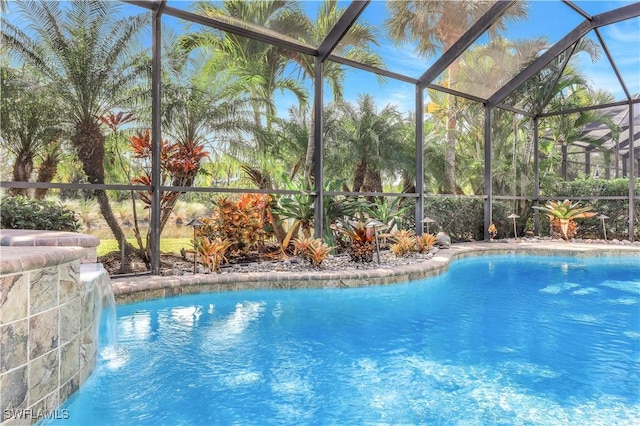 view of pool with pool water feature and a lanai