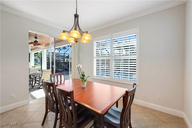 dining area with light tile patterned floors, ceiling fan with notable chandelier, and ornamental molding