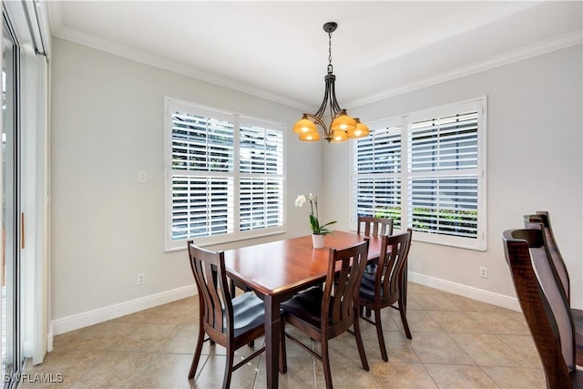 tiled dining space with a notable chandelier and ornamental molding