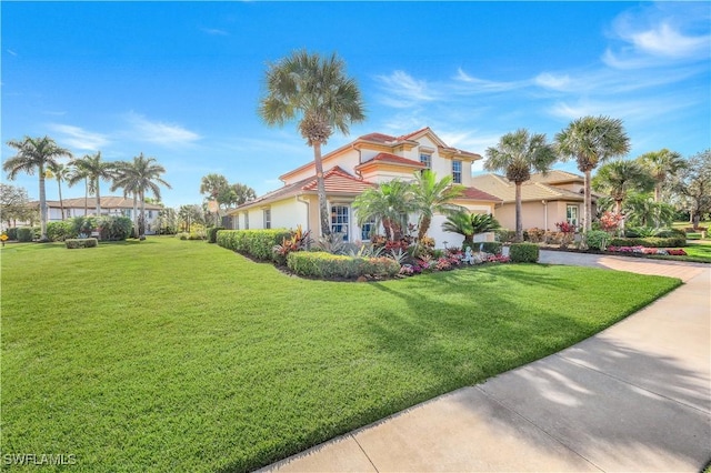 view of front of property with a garage and a front lawn