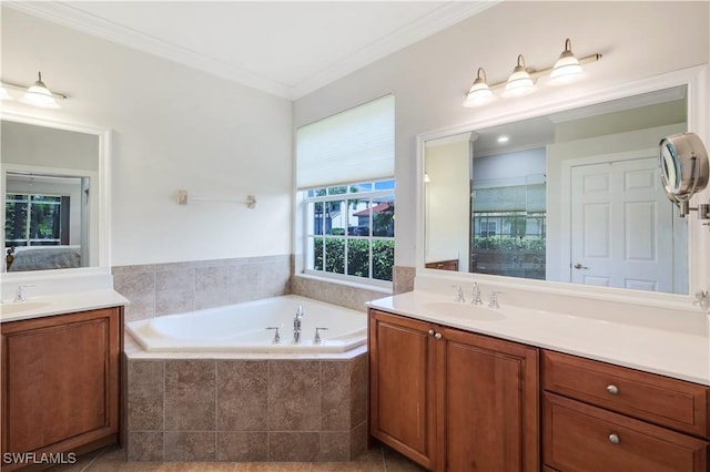 bathroom with vanity, a relaxing tiled tub, and ornamental molding